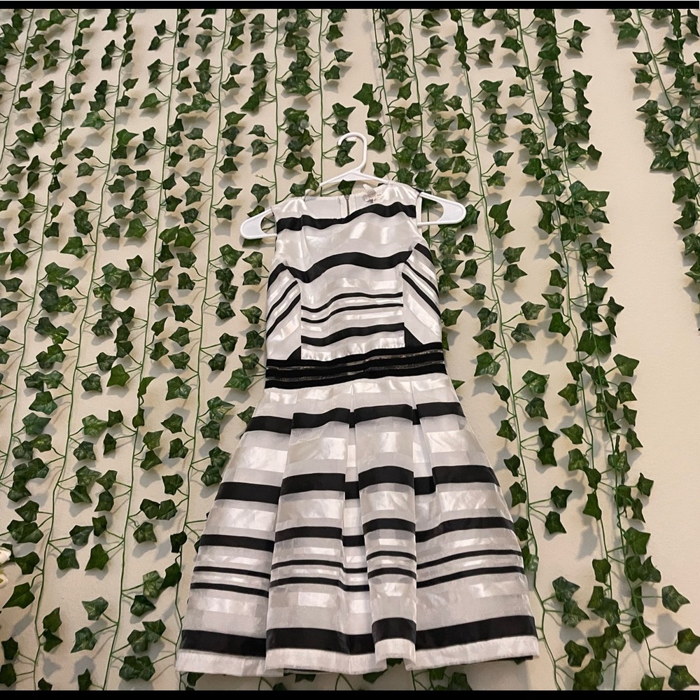 It’s a sleeveless medium black and white dress